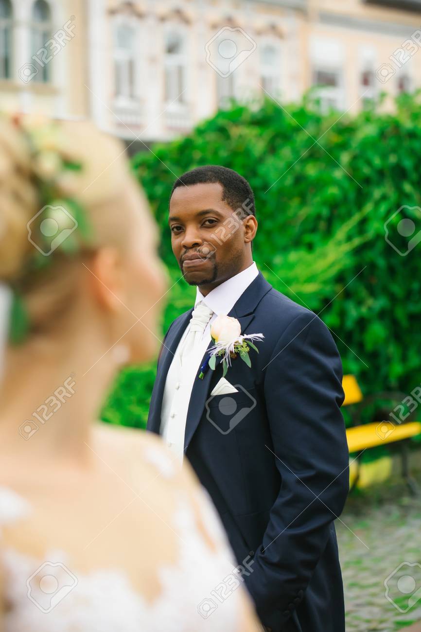 Elegant Man African American Groom Looks At Beautiful Bride Blond