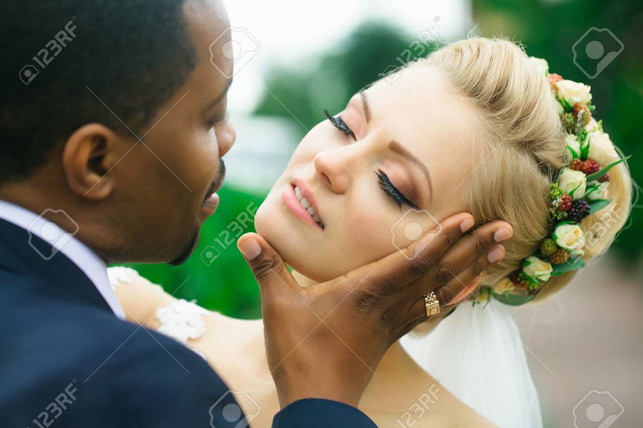 Loving Groom African American Man Gently Touches Face Of Beautiful