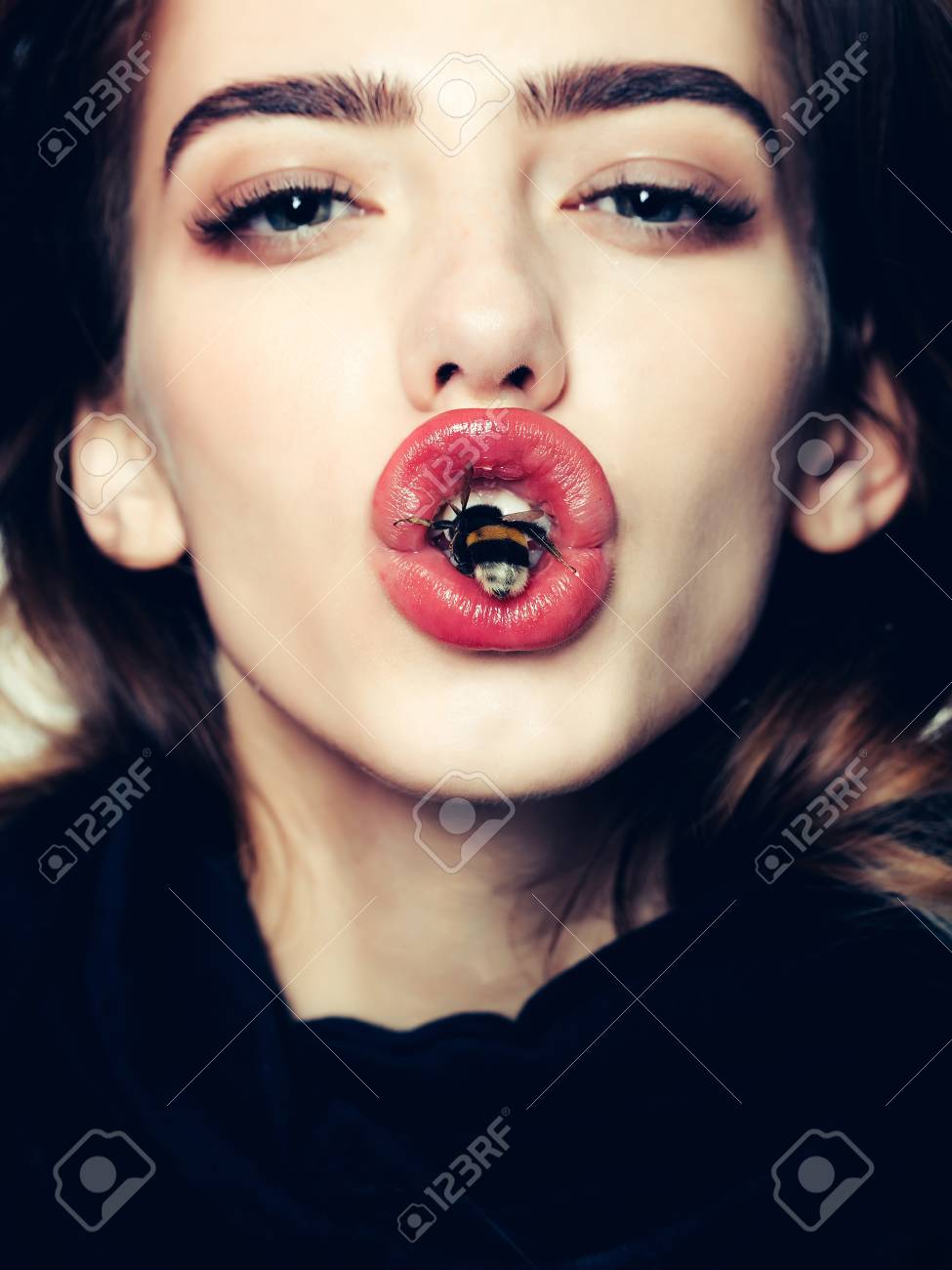 Sexy Young Fashionable Girl Or Woman With Beautiful Red Lips Pretty Cute  Face Stylish Hair And Humblebee Bee In Mouth In Erotic Black Scarf, Closeup  Stock Photo, Picture and Royalty Free Image.