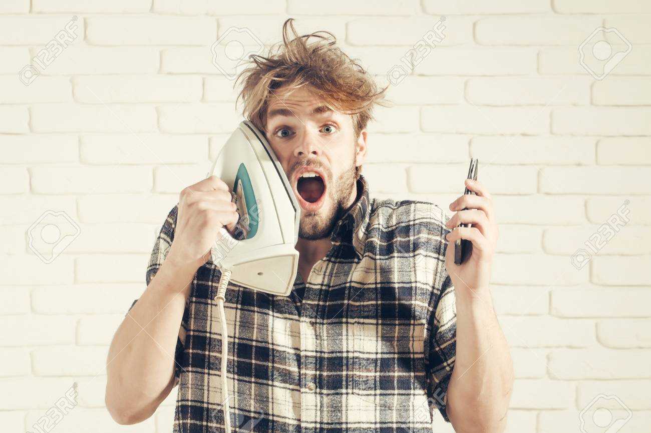 Handsome Surprised Man With Messy Hair With White Iron At His
