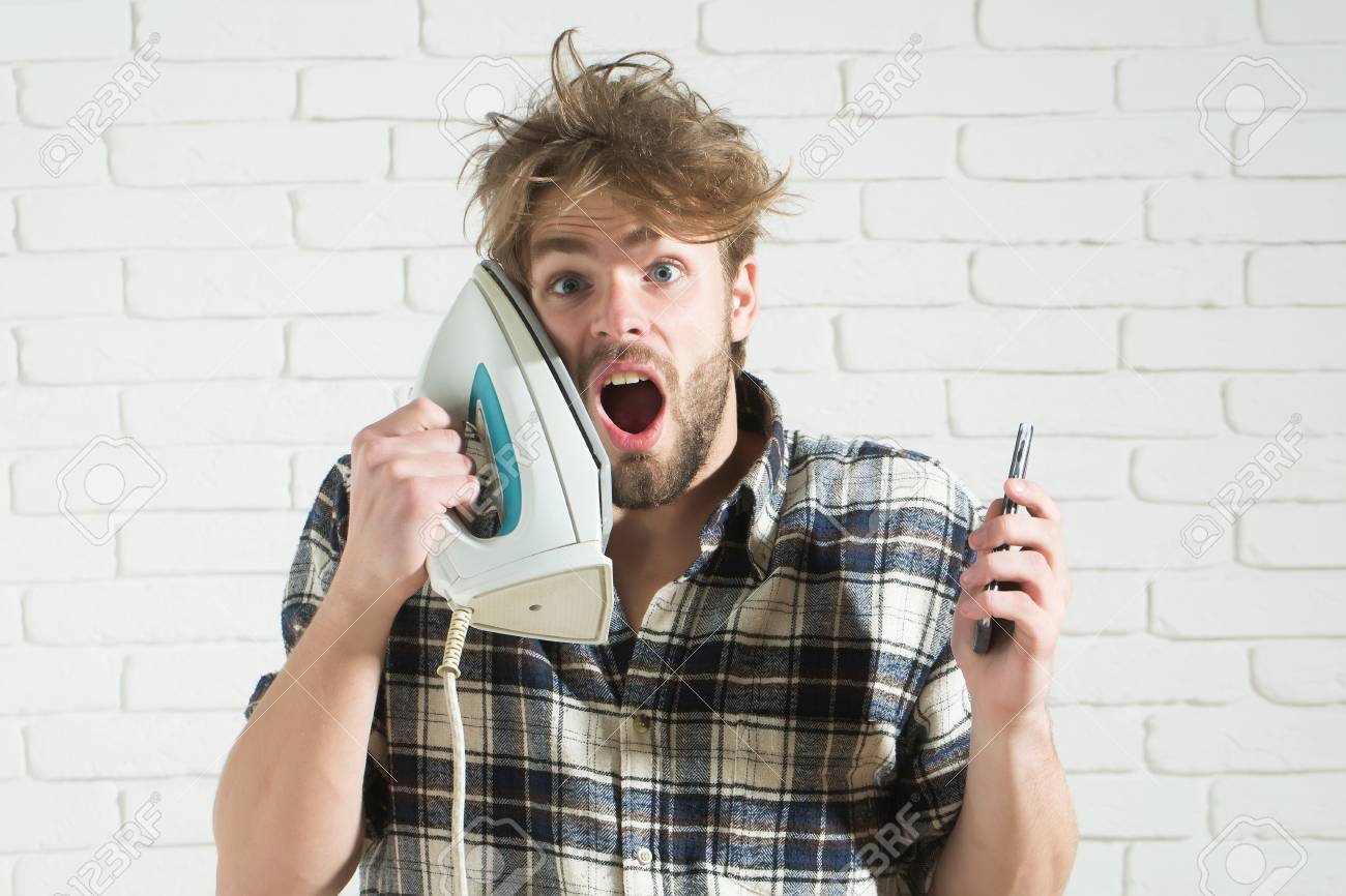 Handsome Surprised Man With Messy Hair With White Iron At His
