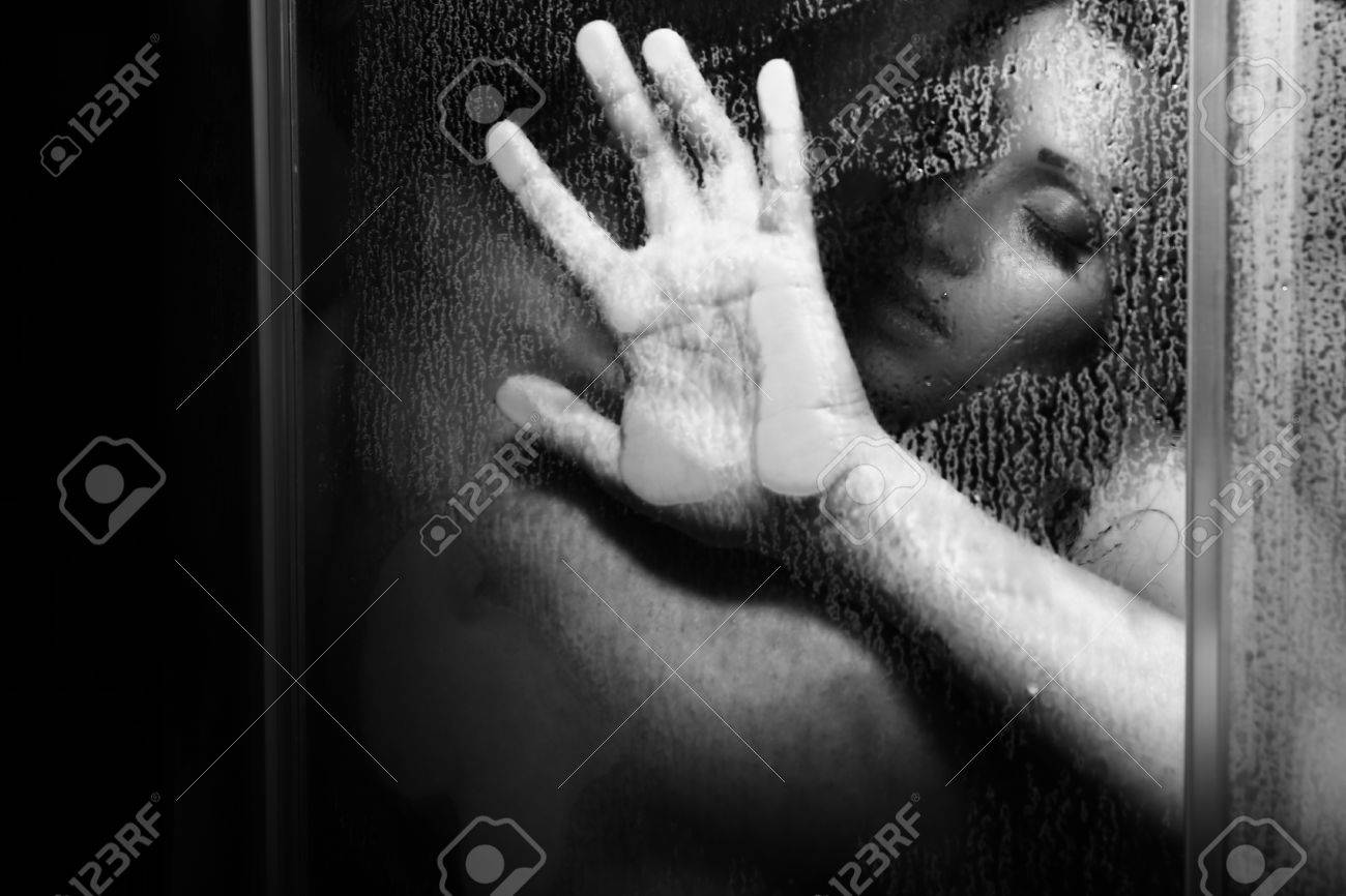 Steamy shower embrace with bodies pressed together under cascading water