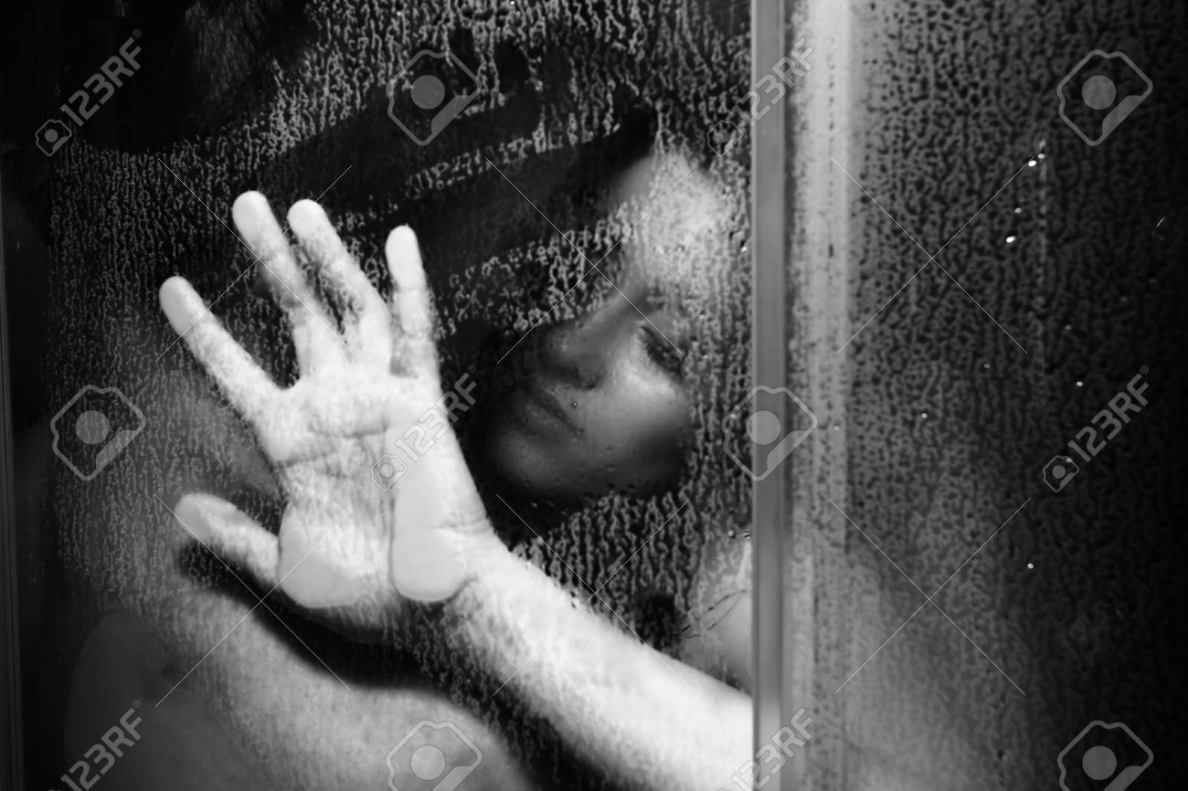 Steamy shower embrace with water droplets on naked bodies