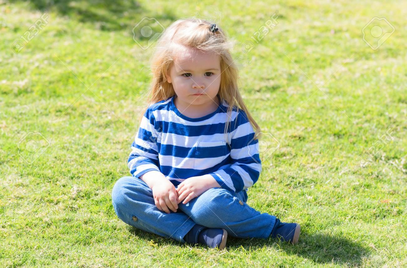 La Mode Enfant Petit Petit Enfant Garcon Mignon Bebe Avec De Longs Cheveux Blonds Dans Des Vetements Bleu Elegant Sur L Herbe Verte Dans Le Parc Ou Jardin Ensoleille En Plein Air L Ete