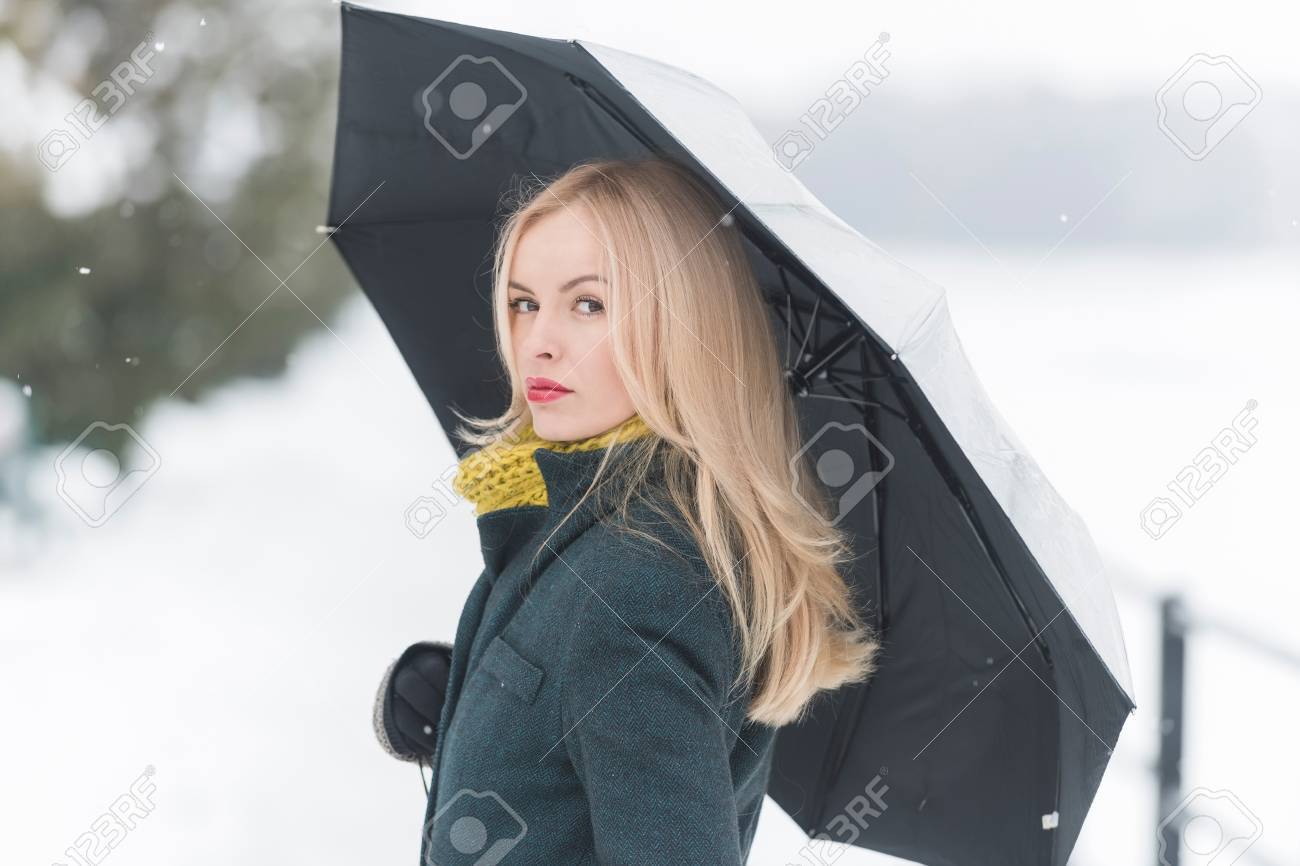 Girl with long blond hair on white snow landscape. Woman walking under umbrella on winter day. Leisure and vacation. Christmas and new year concept. - 84908103 Girl with long blond hair on white snow landscape. Woman walking under umbrella on winter day. Leisure and vacation. Christmas and new year concept. - 84908103