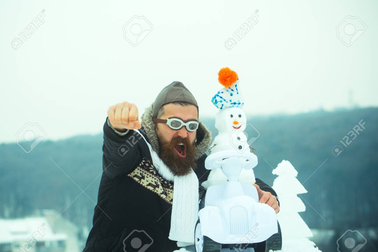 88466573-man-in-pilot-hat-and-glasses-with-raised-fist-hand-excited-hipster-shouting-on-winter-landscape-snow.jpg