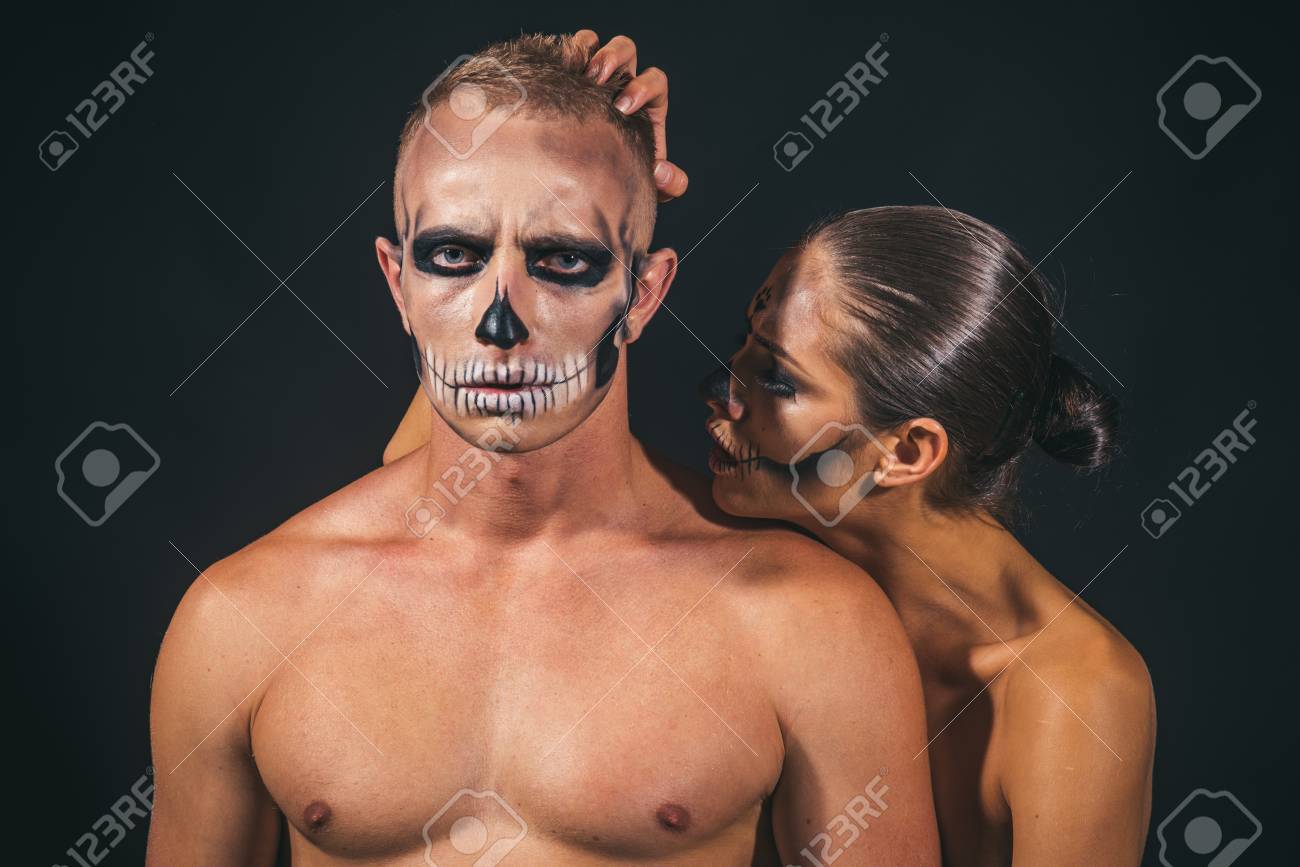 Halloween Couple With Makeup On Face On Black Background. Couple In Love  With Naked Body. Woman And Man Has Scary Face Embrace. Halloween Holiday  And Celebration. Zombie Party And Horror. Фотография, картинки,
