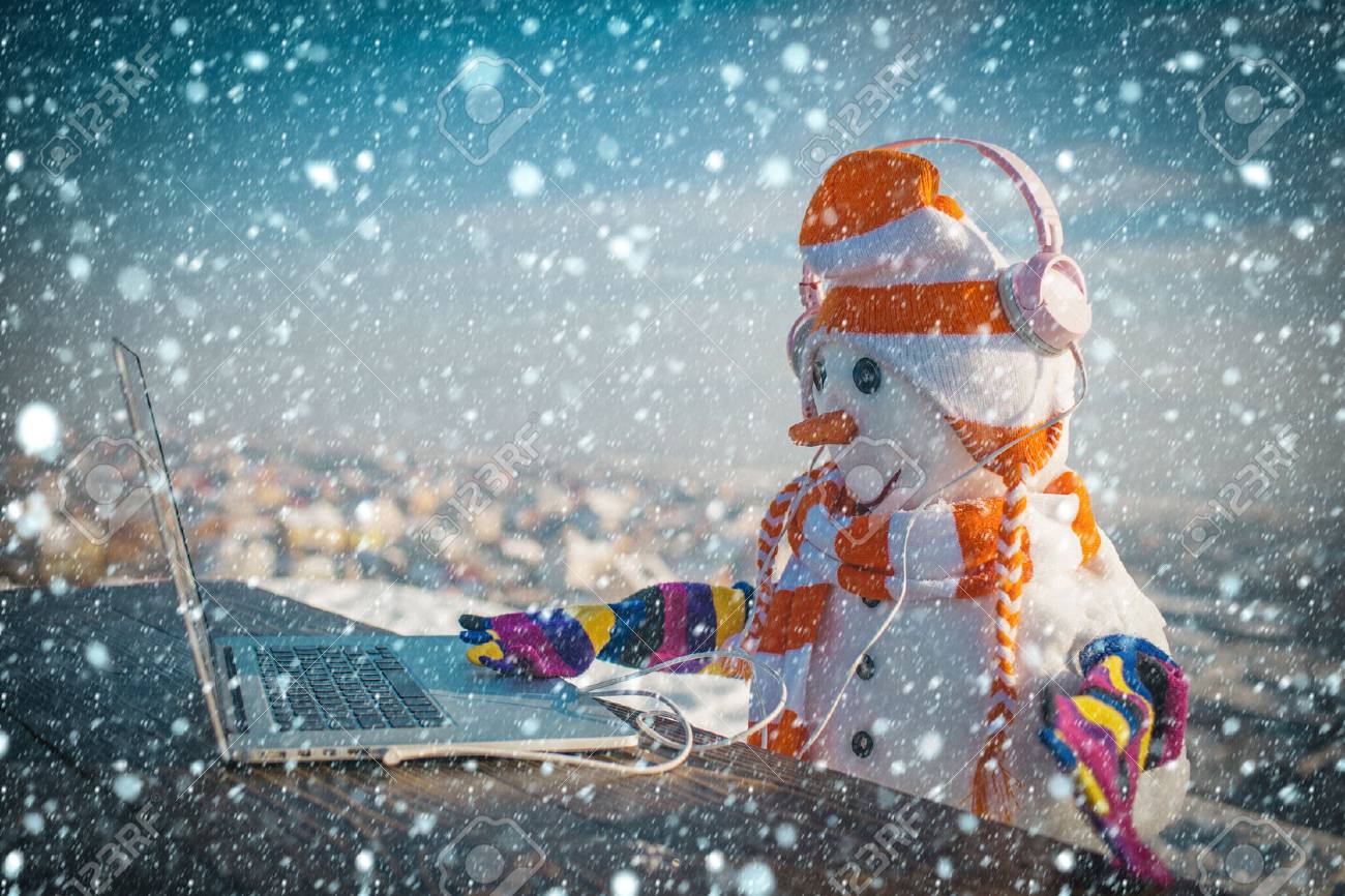 Snowman in winter with laptop, headset and tea cup. - 90502081 Snowman in winter with laptop, headset and tea cup. - 90502081