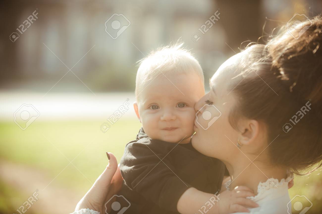 woman kiss child with love mother and little son mom and baby boy