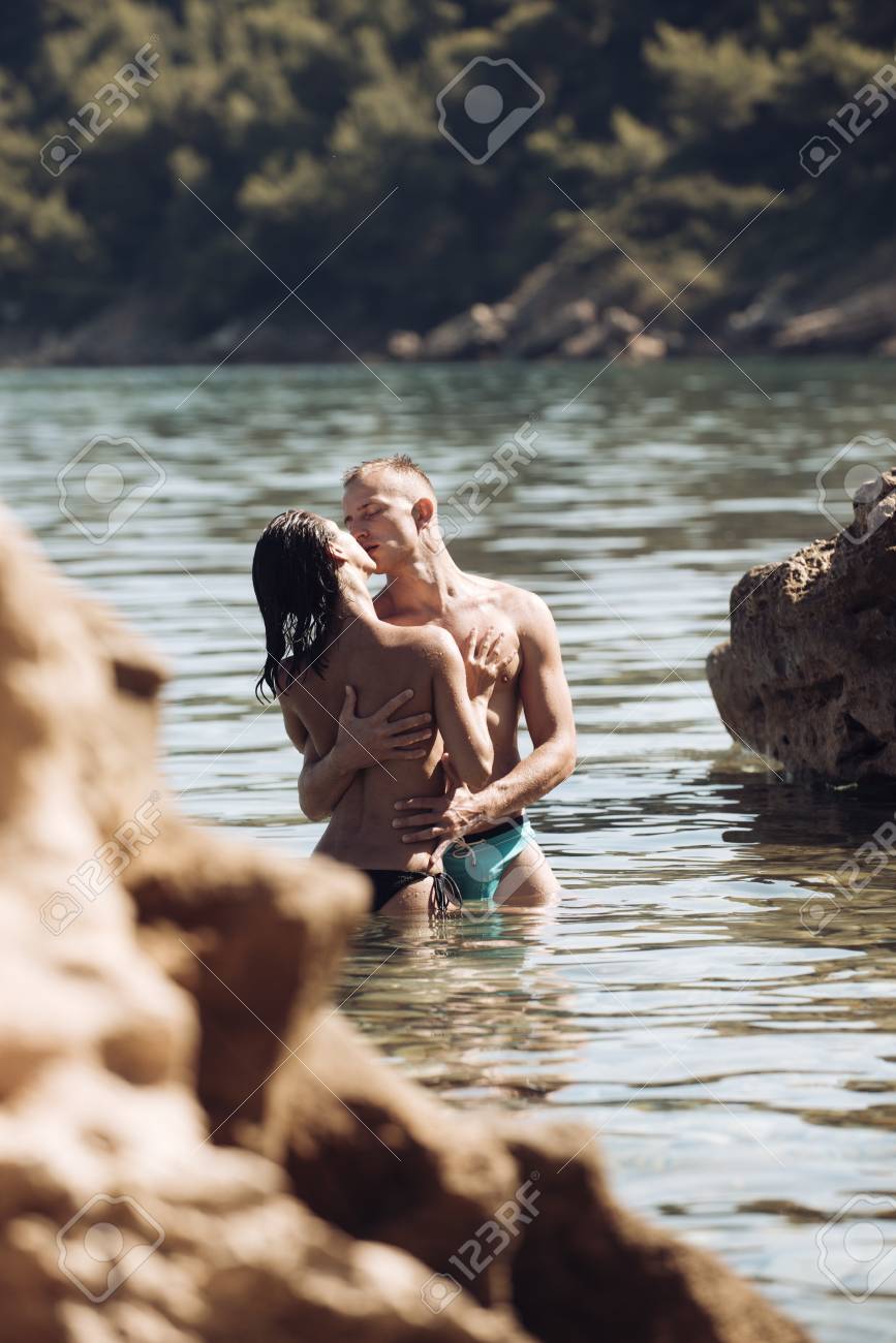 Summer Holidays And Travel On Vacation. Love Relations Of Naked Couple In Sea Water. Family And Valentines Day Concept