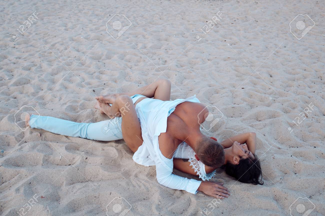 Sex on beach concept. Couple full of desire have on sand of seashore. Sensual lovers making love at seashore. Couple in love have sex, makes love on sand beach. - 101625733 Sex on beach concept. Couple full of desire have on sand of seashore. Sensual lovers making love at seashore. Couple in love have sex, makes love on sand beach. - 101625733