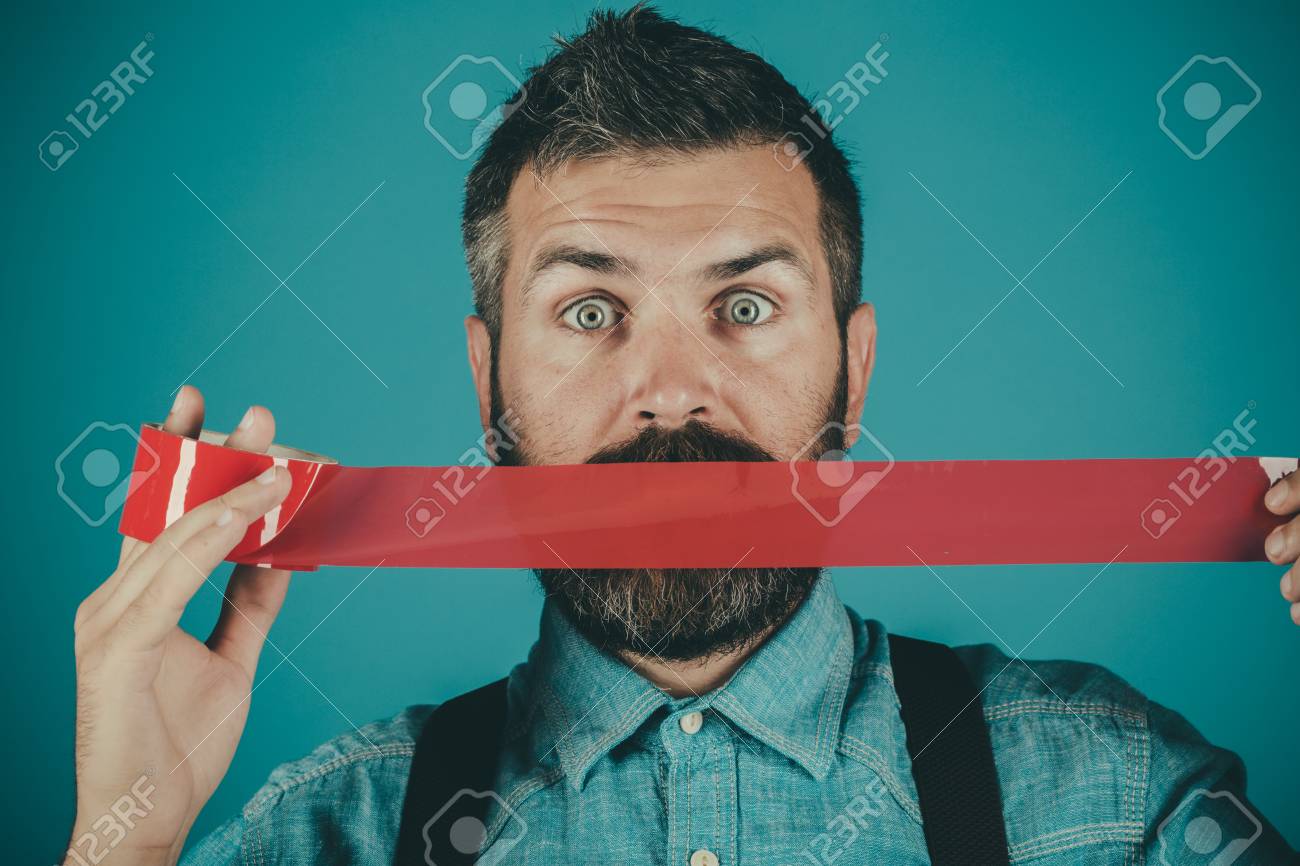 man wrapping mouth by adhesive tape. - 111835687 man wrapping mouth by adhesive tape. - 111835687