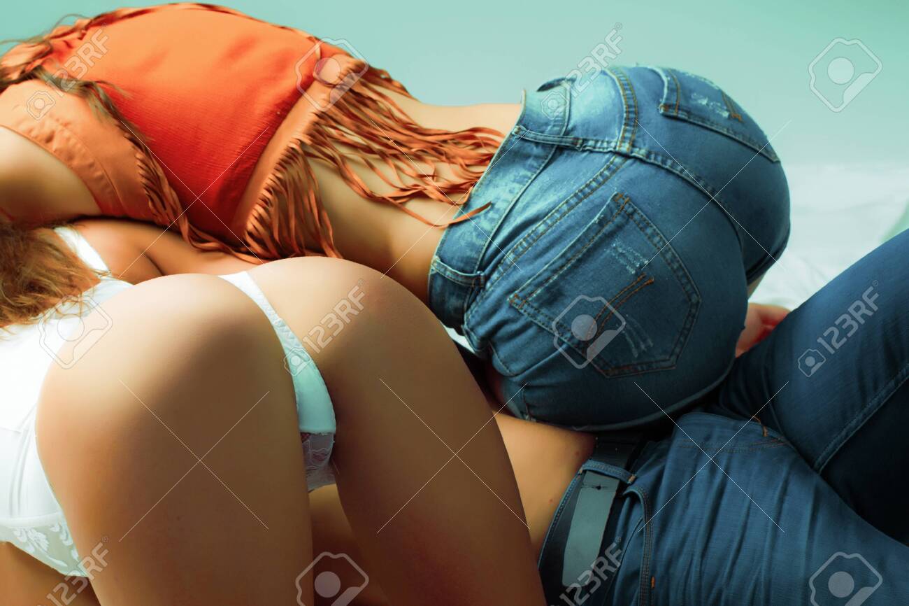 Two Sexy Butt On Man. Womans Buttocks In Intime Moment. Sex Pose And Sensual Prelude. Man Two Women Connected In Bed. Lisbian