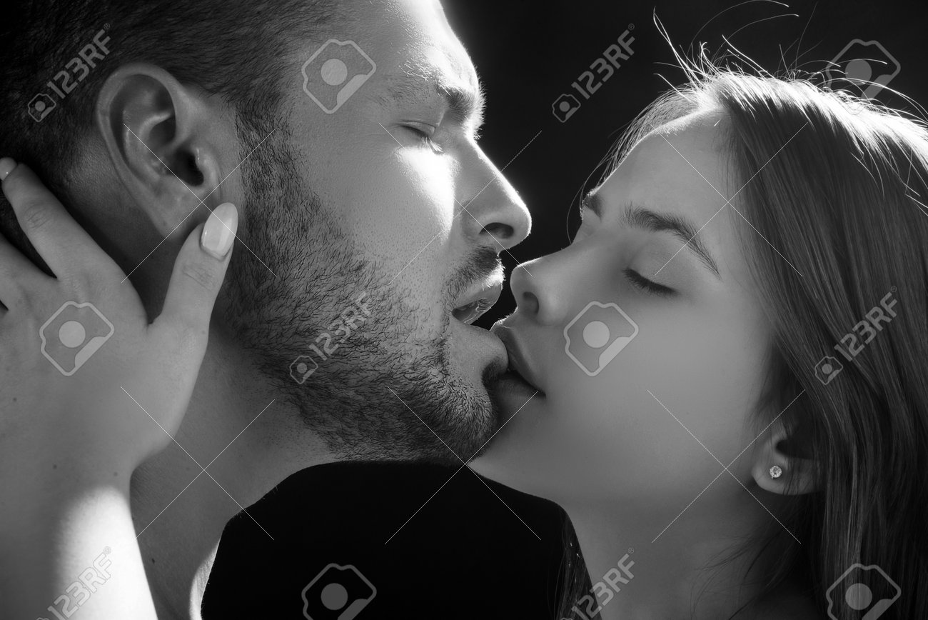 Black and white intense lovers' kiss, raw passion and ecstasy captured