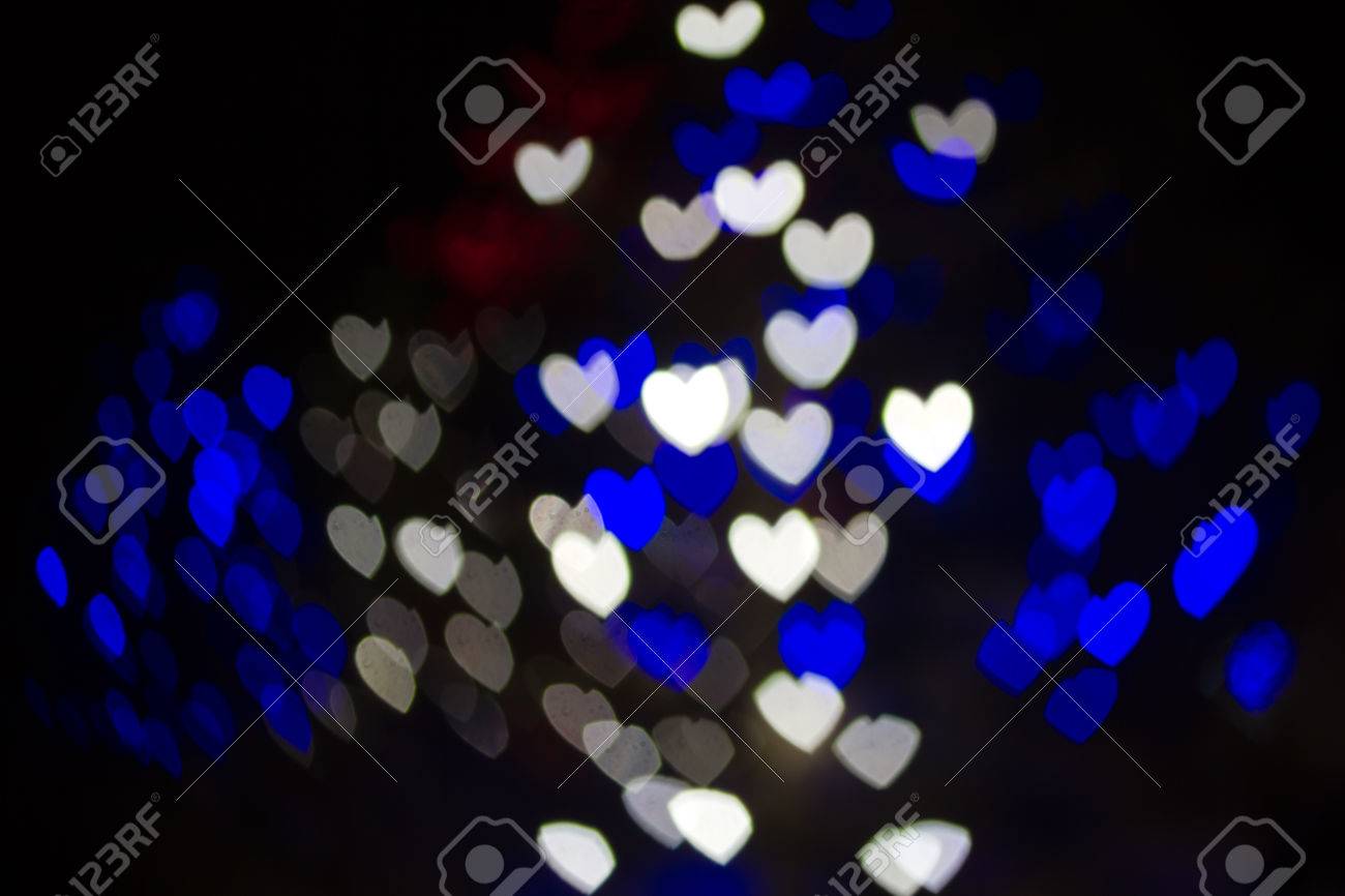 abstract heart shaped bokeh background of blue and white christmas