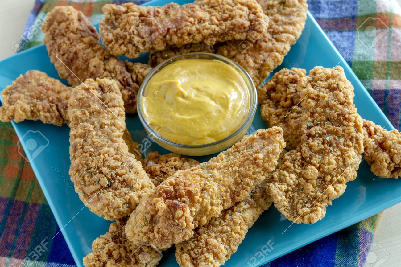 Honey Mustard Dipping Sauce Surrounded With Fried Chicken Tenders Stock Photo Picture And Royalty Free Image Image 89464473