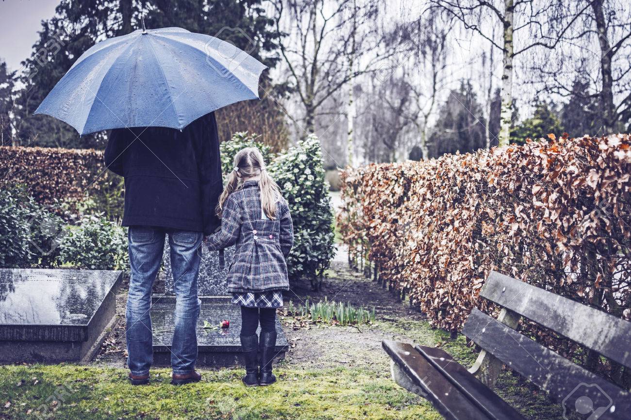 Father and daughter at grave - 26592868 Father and daughter at grave - 26592868