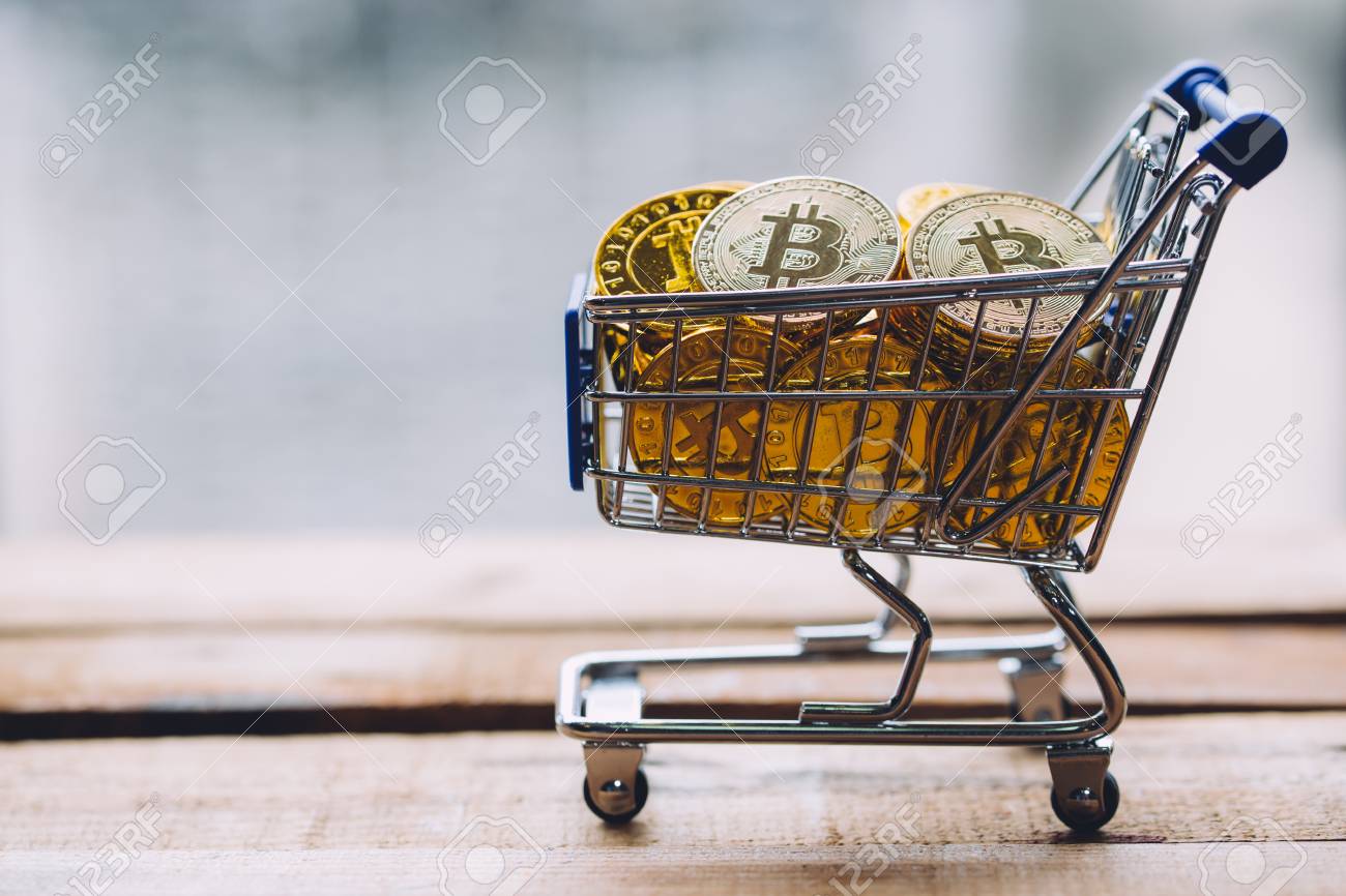 Shopping Cart Filled With Piles Of Cryptocurrency Bitcoin Coins On Wooden  Platform Stock Photo, Picture and Royalty Free Image. Image 98263293.
