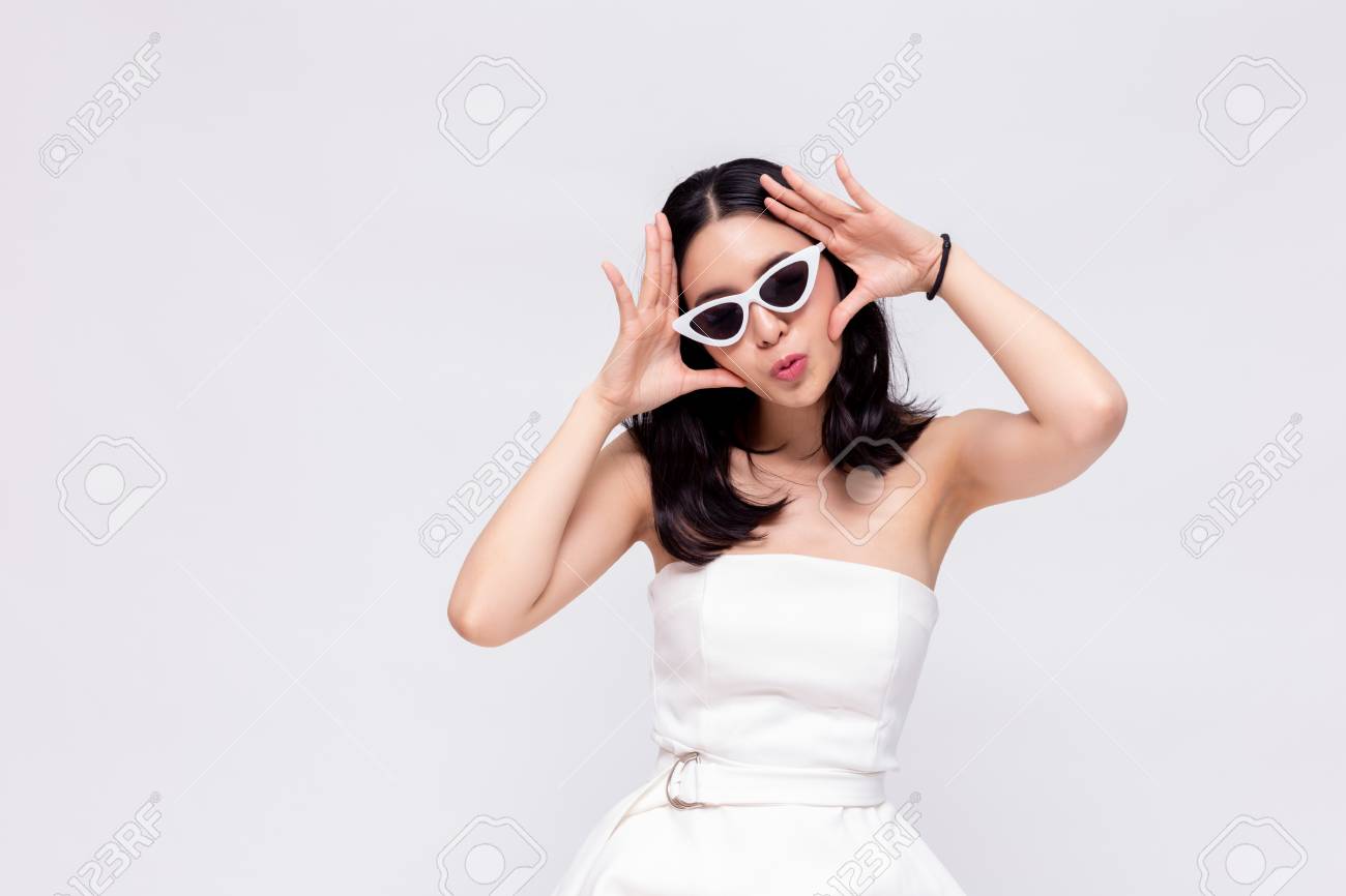 Elegant and attractive Asian chic fashion woman in stylish white dress with sunglasses in isolated background - 105388985 Elegant and attractive Asian chic fashion woman in stylish white dress with sunglasses in isolated background - 105388985