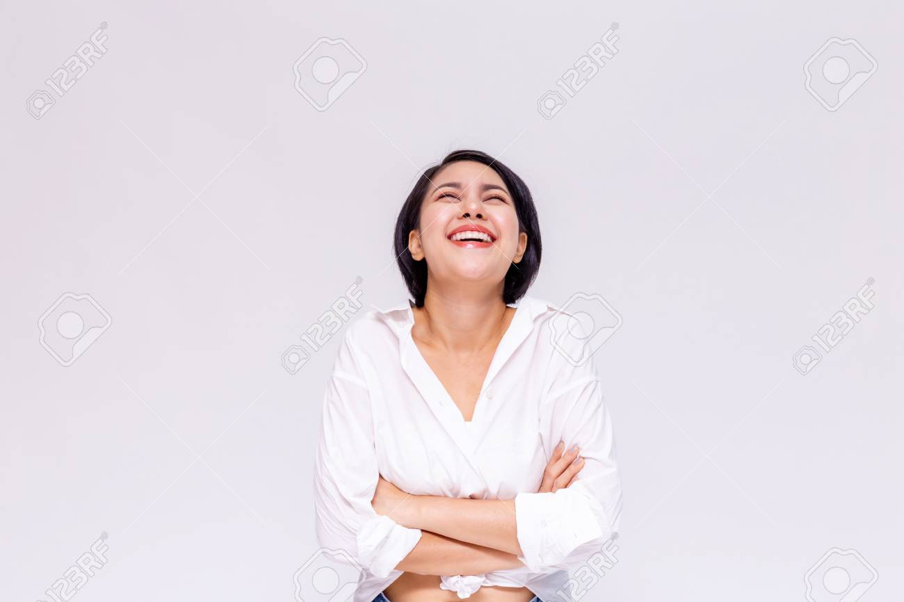 Young beautiful and confident Asian girl with short hair arms crossed with joy and happiness in white isolated background - 105388987 Young beautiful and confident Asian girl with short hair arms crossed with joy and happiness in white isolated background - 105388987