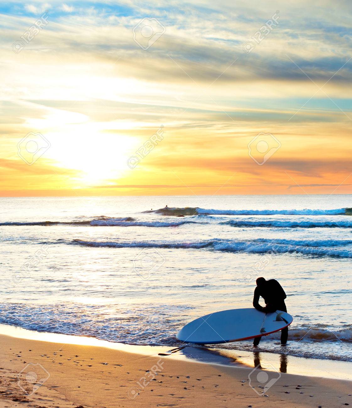 Surfer Getting Ready For Surfing On The Beach At Sunset Stock Photo Picture And Royalty Free Image Image