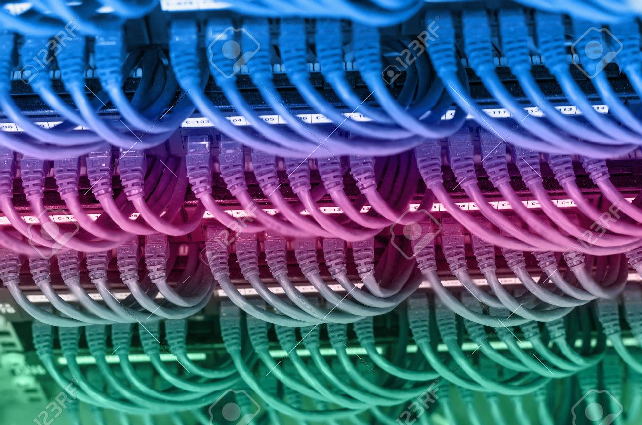 rows of network cable connected to router and switch hub in server