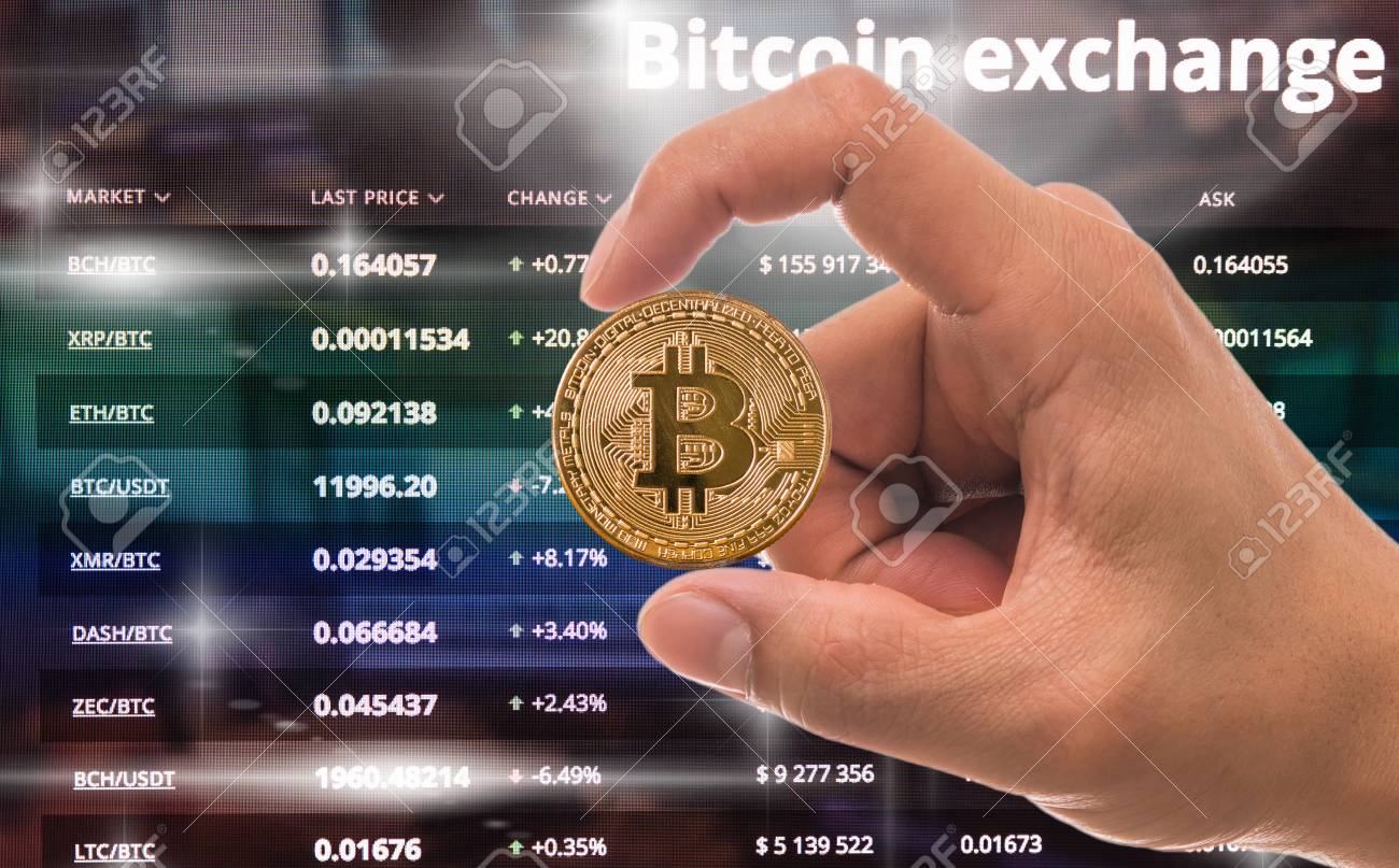 Hand Holding The Bitcoin Mockup Over The Cryptocurrency Trading Screen,  Bitcoin Exchange Screen Of Trading Information, Block Chain Technology Of  Crypto Concept, Business And Market Trade Concept Stock Photo, Picture and  Royalty
