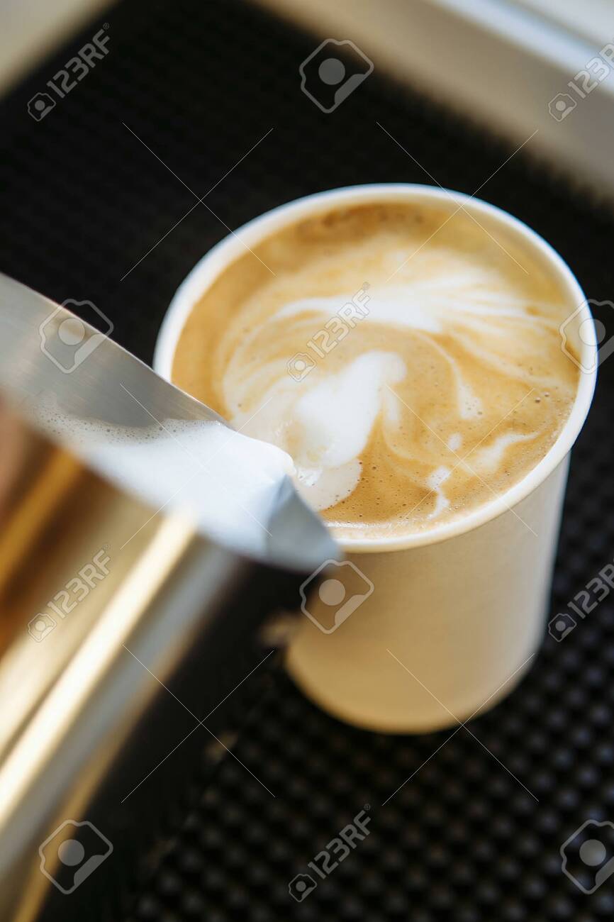 Barista Draws Milk Over A Coffee Making Latte Art For Cappuccino Stock Photo Picture And Royalty Free Image Image 144044102