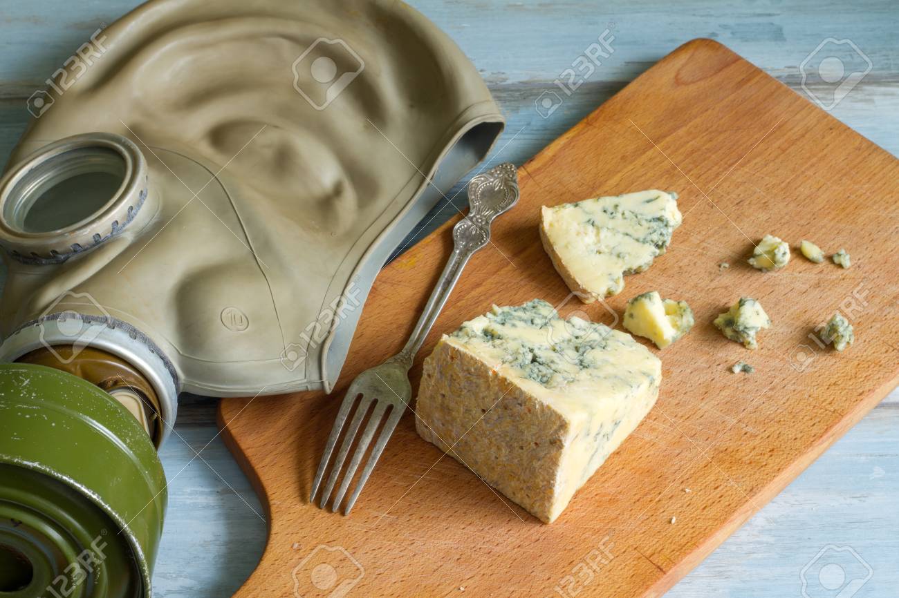 stinky cheese and gas mask funny abstract of food stock photo