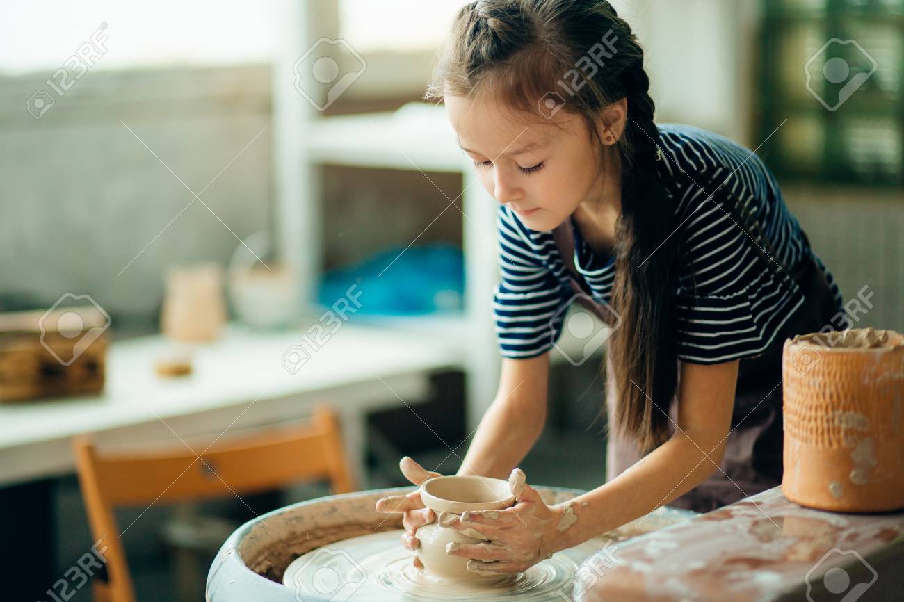 Child sculpts from clay pot. modeling on potter wheel. - 91678839 Child sculpts from clay pot. modeling on potter wheel. - 91678839