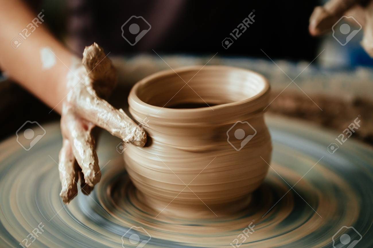 Female potter working at throwing wheel at studio. Clay workshop - 91695865 Female potter working at throwing wheel at studio. Clay workshop - 91695865