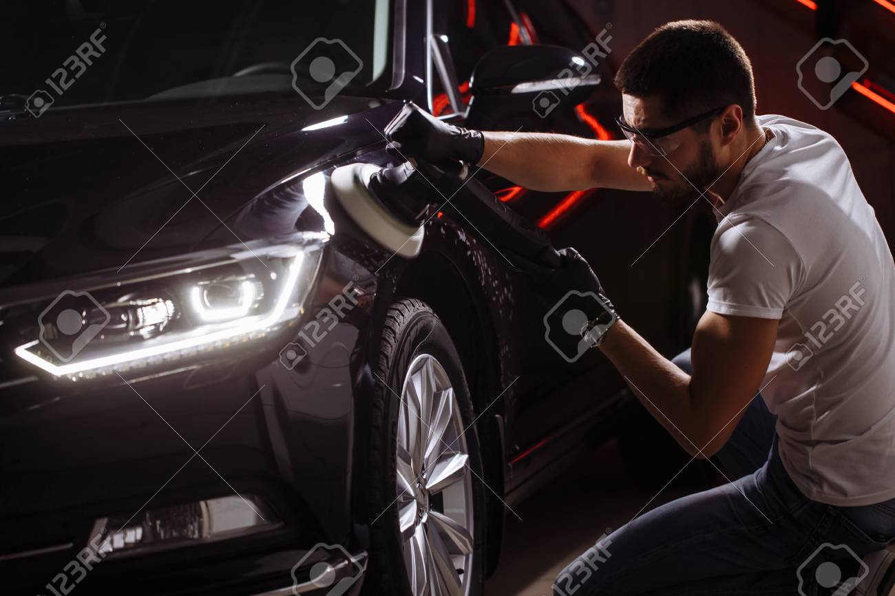 Car detailing - man with orbital polisher in auto repair shop. Selective focus. - 91823855 Car detailing - man with orbital polisher in auto repair shop. Selective focus. - 91823855