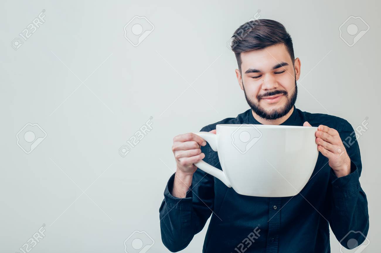 business man holding a funny huge and oversized cup of black coffee in caffeine - 91702028 business man holding a funny huge and oversized cup of black coffee in caffeine - 91702028