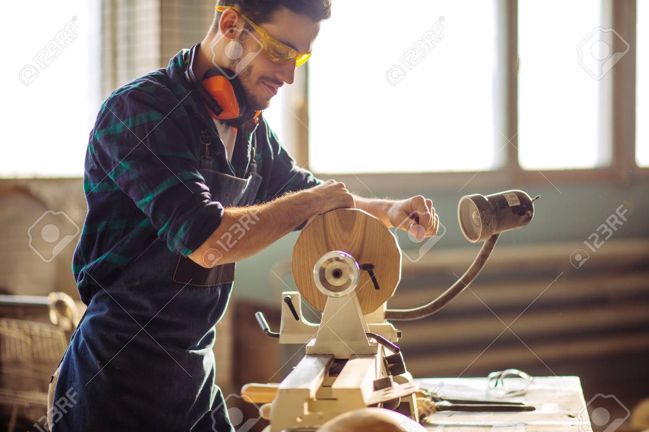 attractive man begin doing woodwork in carpentry - 96502095 attractive man begin doing woodwork in carpentry - 96502095