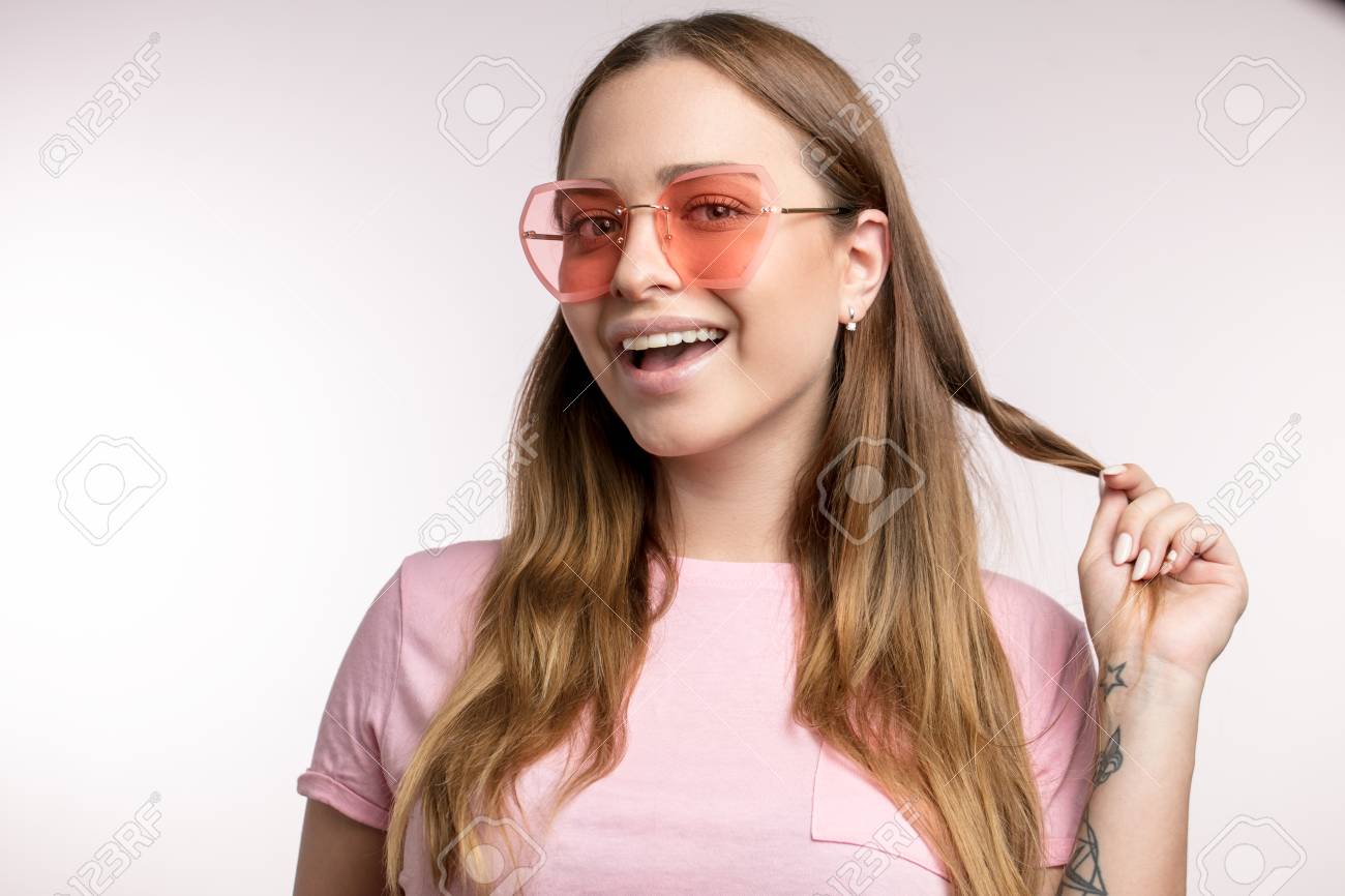 Positive Girl With A Habit Of Twisting Hair Round Finger Stock