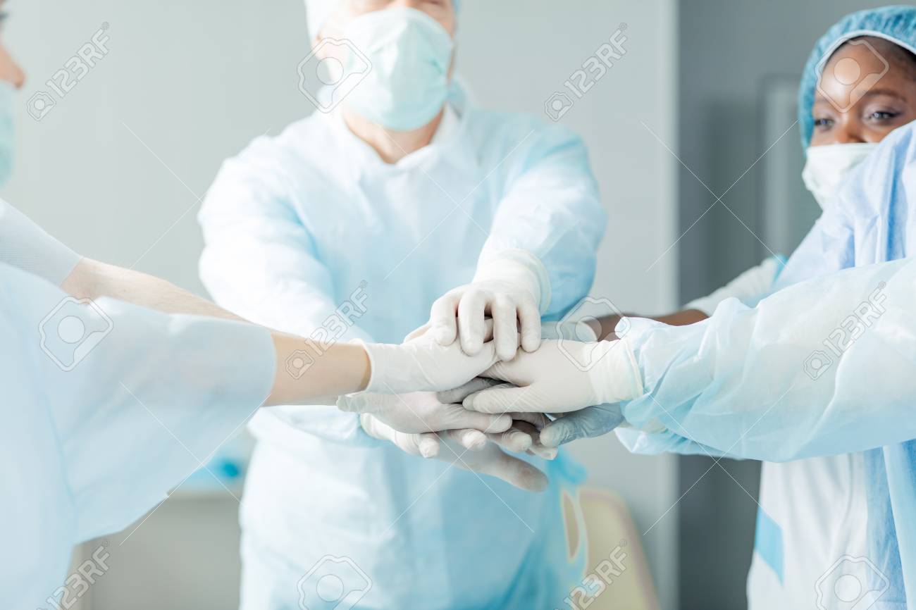 focus on doctors hands. team and unity concept.close up cropped photo. - 124806932 focus on doctors hands. team and unity concept.close up cropped photo. - 124806932