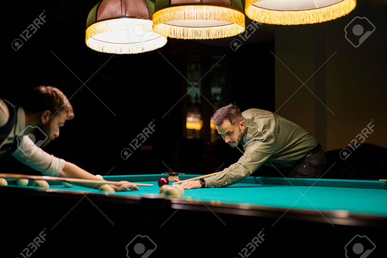 group of people or friends playing fun billiards, snooker or pool together, enjoy leisure time. fun, billiards, leisure, rest concept - 169212525 group of people or friends playing fun billiards, snooker or pool together, enjoy leisure time. fun, billiards, leisure, rest concept - 169212525