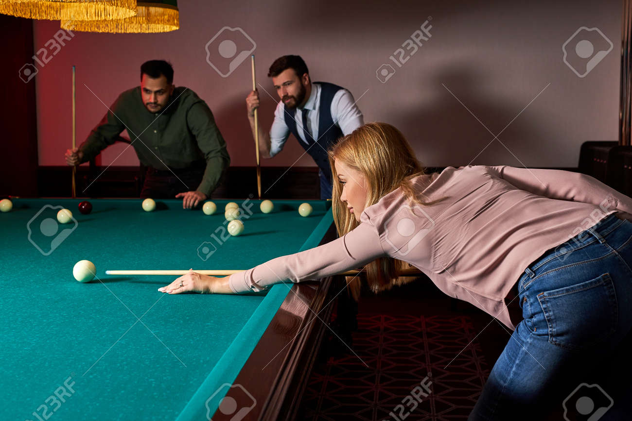 woman playing snooker, she is aiming to shoot the snooker ball, holding hands on snooker table. billiards - 169212620 woman playing snooker, she is aiming to shoot the snooker ball, holding hands on snooker table. billiards - 169212620