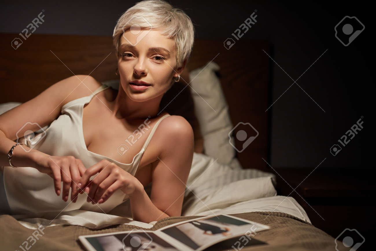 Portrait Of Stylish Lady Lying On Bed Alone, With Magazines Photos On Bed. Elegant Woman Of Caucasian Appearance Having Rest - 169368810 Portrait Of Stylish Lady Lying On Bed Alone, With Magazines Photos On Bed. Elegant Woman Of Caucasian Appearance Having Rest - 169368810
