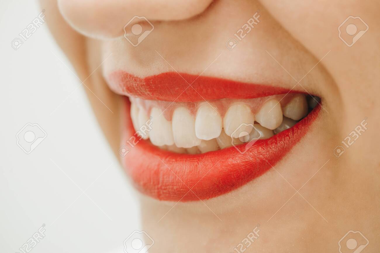 Beautiful toothy smile. Close up portrait of beautiful young happy smiling woman, isolated over white background. Laughing woman smile with great teeth. - 151468217 Beautiful toothy smile. Close up portrait of beautiful young happy smiling woman, isolated over white background. Laughing woman smile with great teeth. - 151468217