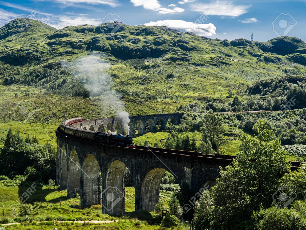 Steam Train Passing A Viaduct Between Fort William And Mallaig