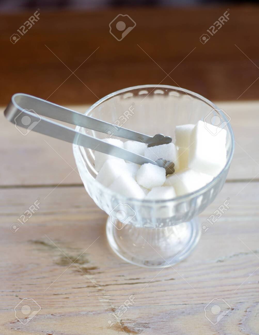 Lump Sugar In Crystall Vase With Sugar Tongs Close Up Photo On