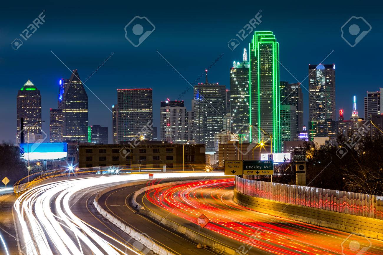Dallas skyline by night. The rush hour traffic leaves light trails on I30 Tom Landry freeway. - 41904818 Dallas skyline by night. The rush hour traffic leaves light trails on I30 Tom Landry freeway. - 41904818