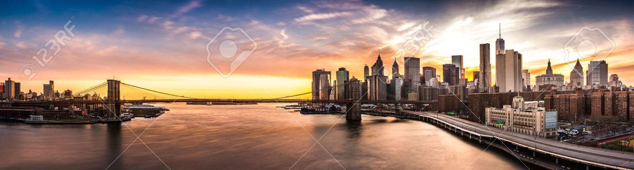 Brooklyn Bridge panorama at sunset. The iconic landmark spans between Brooklyn and the New York Financial District skyline, dominated by the Freedom Tower. - 45882424 Brooklyn Bridge panorama at sunset. The iconic landmark spans between Brooklyn and the New York Financial District skyline, dominated by the Freedom Tower. - 45882424