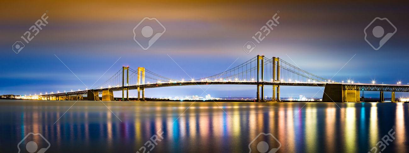 Delaware Memorial Bridge by night, viewed from New Jersey. The Delaware Memorial Bridge is a set of twin suspension bridges crossing the Delaware River between the states of Delaware and New Jersey - 47588099 Delaware Memorial Bridge by night, viewed from New Jersey. The Delaware Memorial Bridge is a set of twin suspension bridges crossing the Delaware River between the states of Delaware and New Jersey - 47588099
