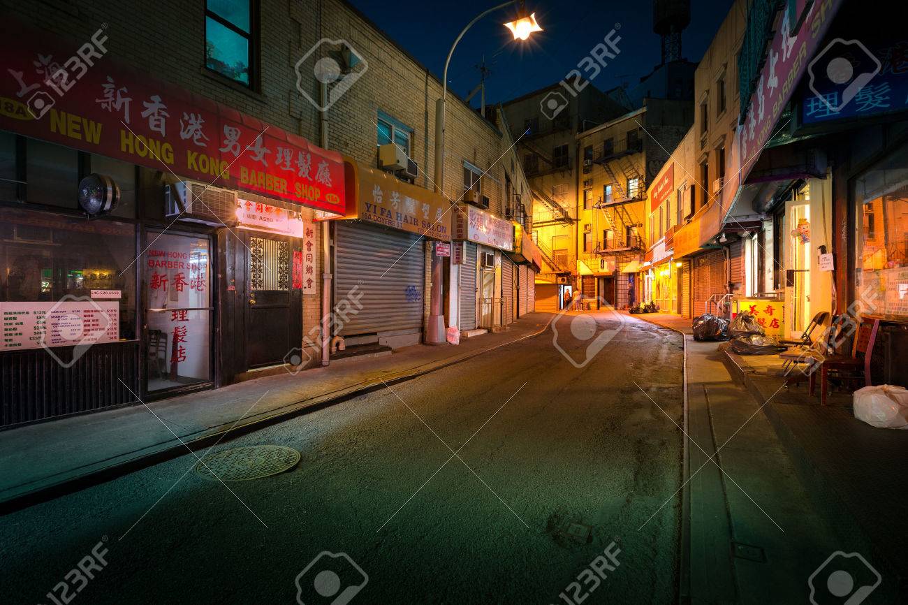 NEW YORK - JUNE 18, 2016: Doyers Street by night, in NYC Chinatown. The bend became known as "the Bloody Angle" because of numerous gang shootings. - 58937924 NEW YORK - JUNE 18, 2016: Doyers Street by night, in NYC Chinatown. The bend became known as "the Bloody Angle" because of numerous gang shootings. - 58937924