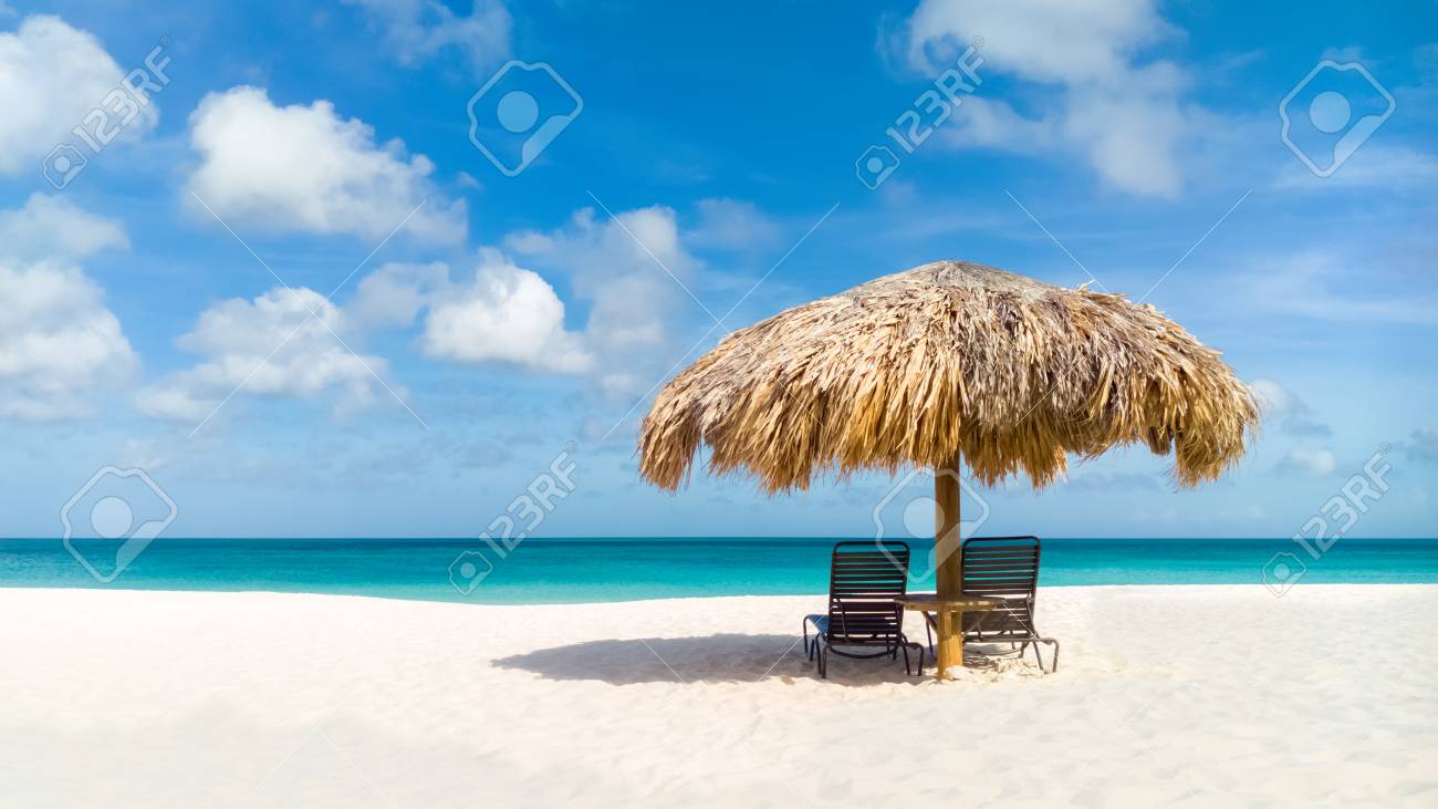 Straw umbrella on Eagle Beach, Aruba on a lovely summer day - 85342913 Straw umbrella on Eagle Beach, Aruba on a lovely summer day - 85342913