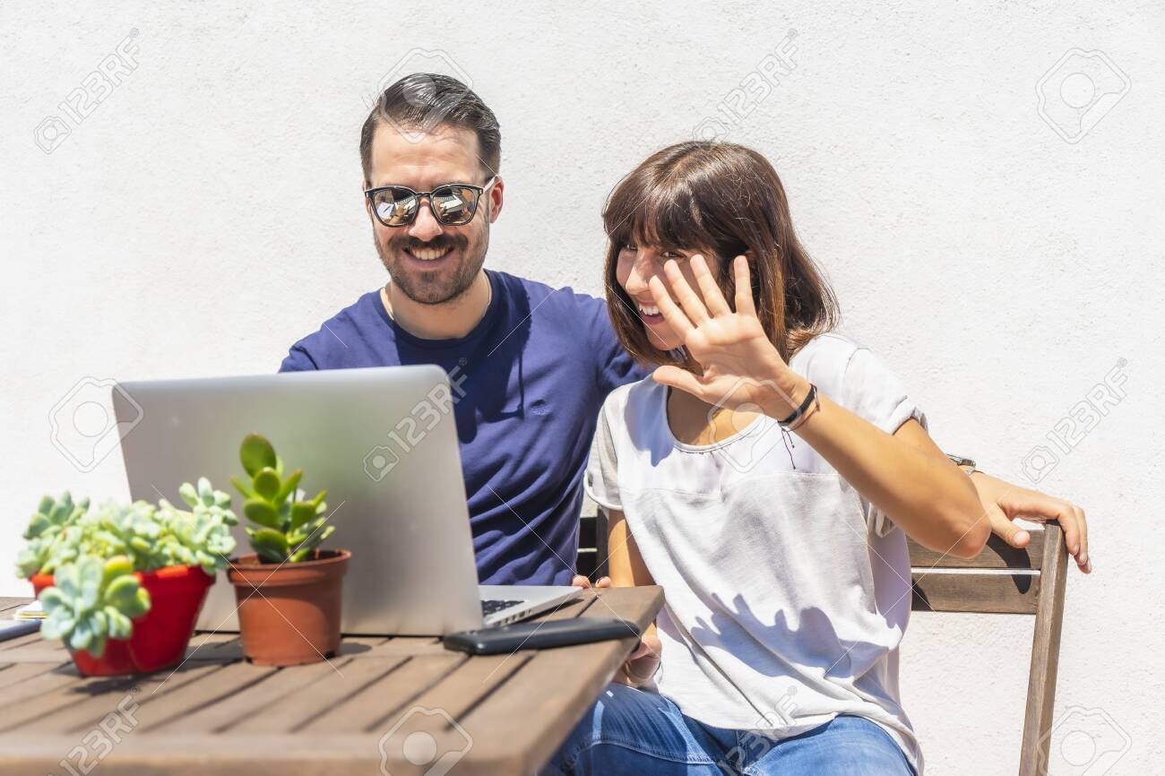 A Couple Confined At Home Making A Video Call With Some Friends Stock Photo Picture And Royalty Free Image Image 151586618