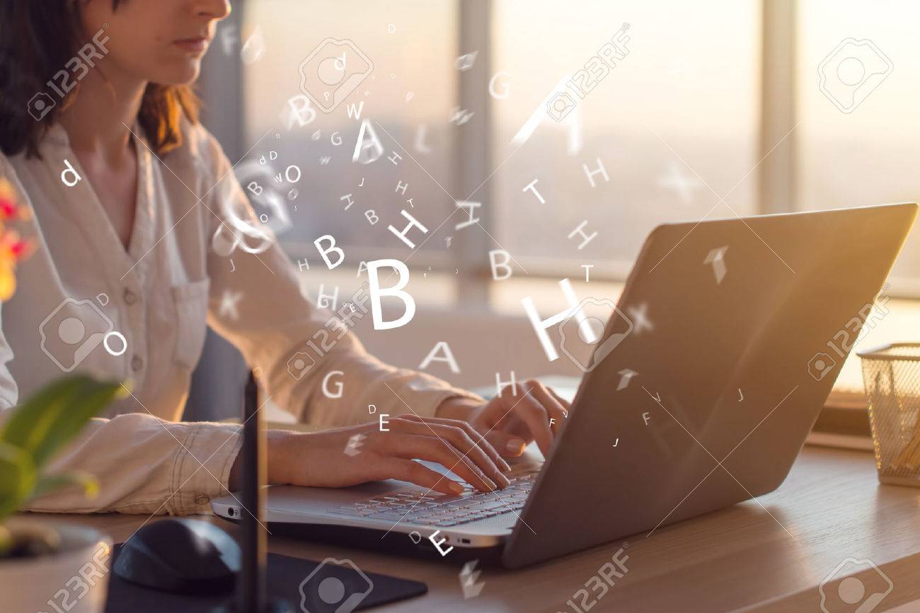 Side view photo of a female using laptop, working, typing, surfing the internet at workplace - 74718673 Side view photo of a female using laptop, working, typing, surfing the internet at workplace - 74718673