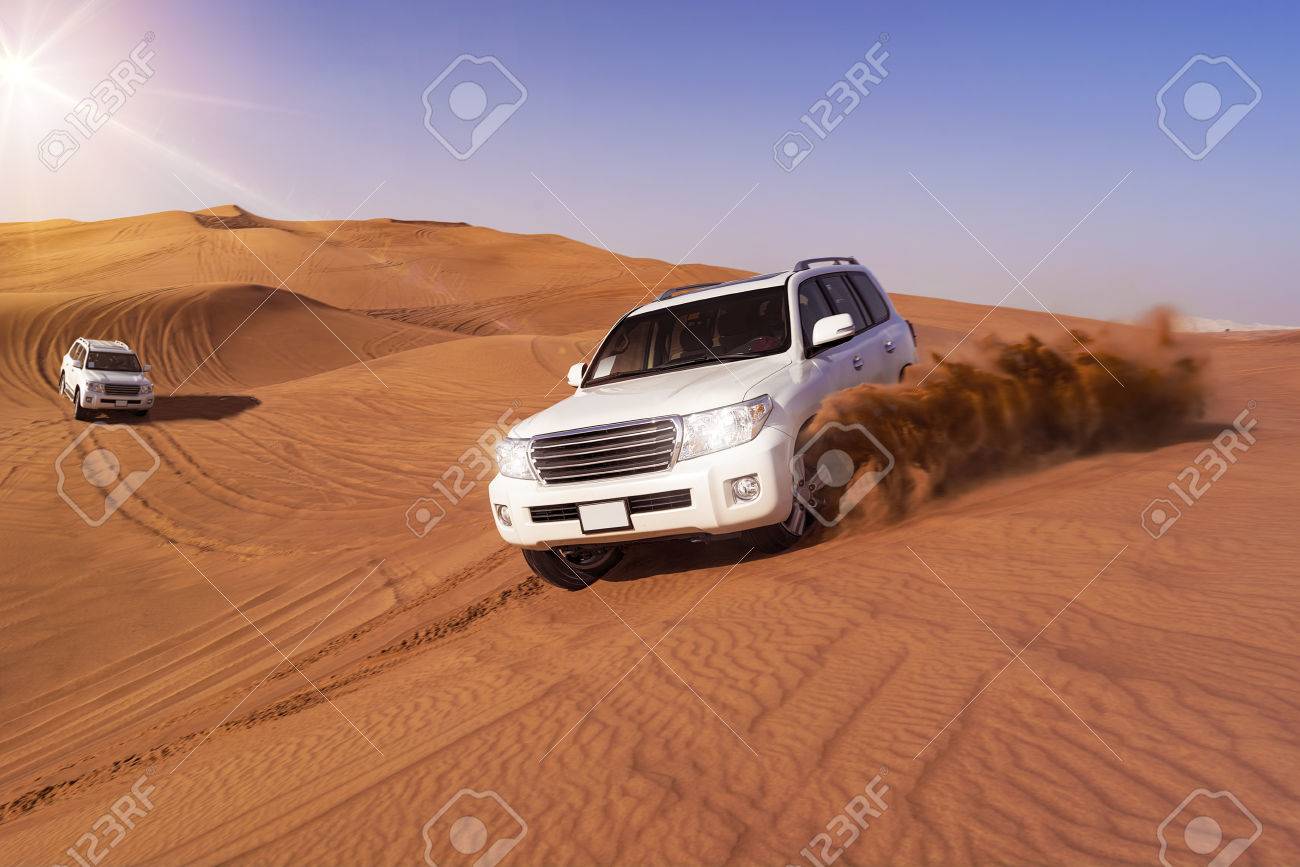 Desert SUVs bashing through the arabian sand dunes - 54905569 Desert SUVs bashing through the arabian sand dunes - 54905569
